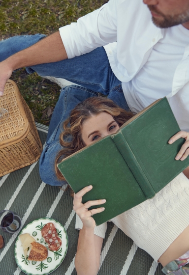 A woman reading a book in Forsyth Park
