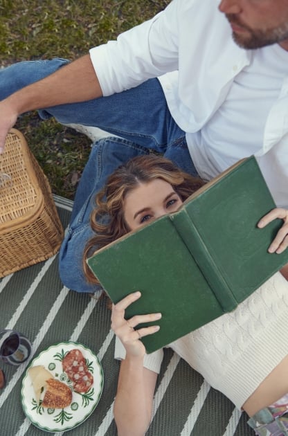 A woman reading a book in Forsyth Park