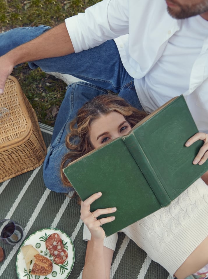 A woman reading a book in Forsyth Park