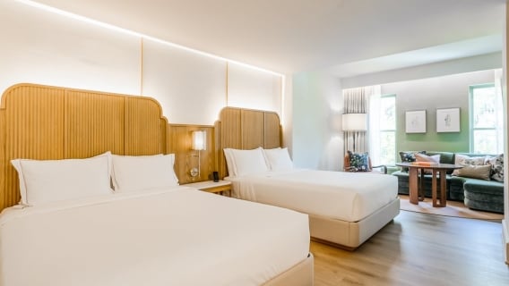 Standard double queen bedroom with a sectional sofa in the lounge area