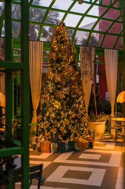 A elegant gold adorned Christmas tree within Bardo's Courtyard event space