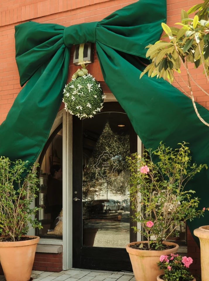 Shop Bardo with a large green bow hung over the entry way